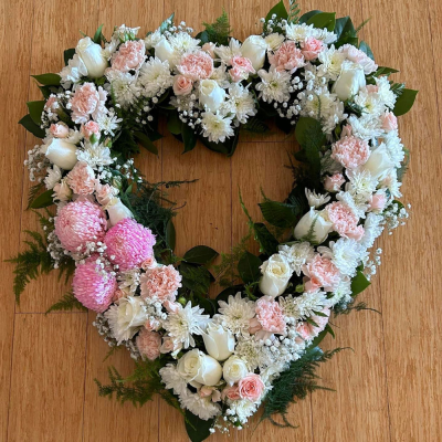 Heart SYM-325 - A beautiful open heart made with a selection of pink flowers specially chosen to make a stunning tribute by our florists.