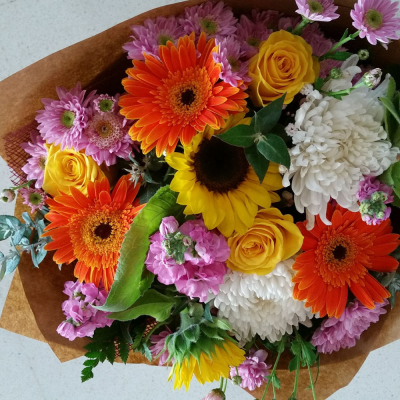 Sunshine Bouquet - A stunning handtied in water presented in a gif bag/box. Created using vibrant flowers with complimentary foliage. Hand delivered with care in and around Perth by Carramar Flowers & Gifts.