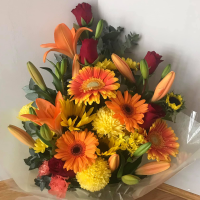 Perfect Sunset - A beautiful handtied in water presented in a gif bag/box. Created using orange, red and yellow flowers complimentary foliage. Hand delivered with care in and around Perth by Carramar Flowers & Gifts.