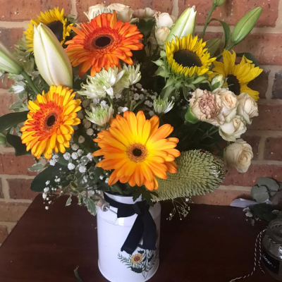 Over the Horizon - A stunning vase arrangement. Created using yellow and orange flowers with complimentary foliage. Hand delivered with care in and around Perth by Carramar Flowers & Gifts.